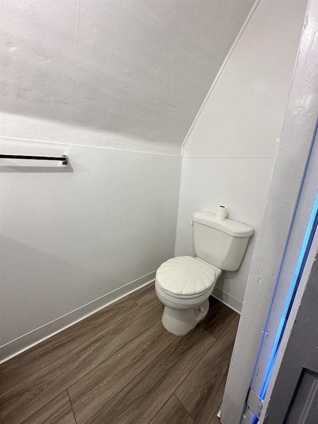 N2224 Wafle Rd, Mauston, WI 53948 - bathroom featuring wood finished floors, toilet, and lofted ceiling