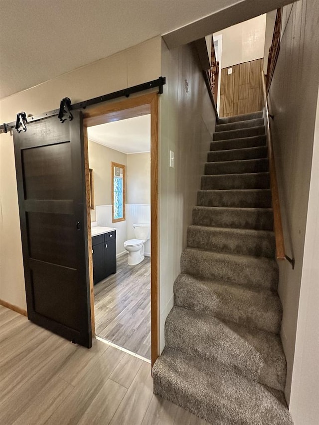 N2224 Wafle Rd, Mauston, WI 53948 - stairs with a barn door and wood finished floors