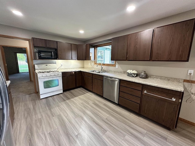 N2224 Wafle Rd, Mauston, WI 53948 - kitchen with white gas stove, dishwasher, a sink, dark brown cabinets, and recessed lighting
