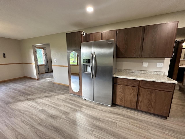 N2224 Wafle Rd, Mauston, WI 53948 - kitchen featuring stainless steel fridge, light countertops, dark brown cabinets, baseboards, and light wood-style floors