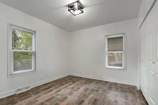 1107 Perry Ave, Racine, WI 53406 - empty room with baseboards and dark wood finished floors