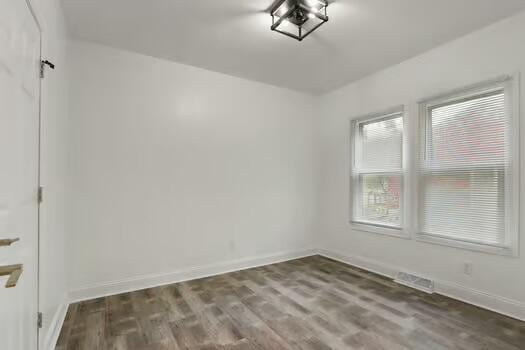 1107 Perry Ave, Racine, WI 53406 - empty room featuring baseboards and wood finished floors