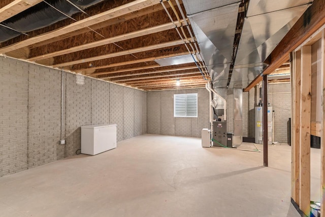 160 Candleberry Ln, Grafton, WI 53024 - below grade area featuring water heater, fridge, and heating unit