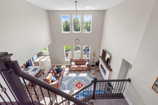 160 Candleberry Ln, Grafton, WI 53024 - living area featuring a towering ceiling, a chandelier, baseboards, wood finished floors, and stairway
