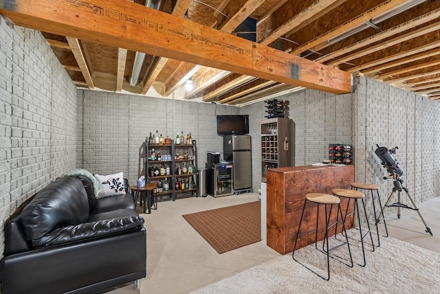 160 Candleberry Ln, Grafton, WI 53024 - bar area with freestanding refrigerator, concrete flooring, and brick wall