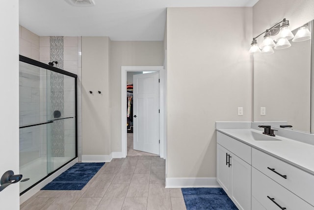 160 Candleberry Ln, Grafton, WI 53024 - full bathroom featuring baseboards, a spacious closet, vanity, and a shower stall