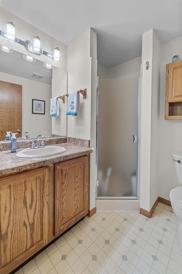 W5204 N Osprey Dr, New Lisbon, WI 53950 - bathroom featuring vanity, toilet, a shower stall, and baseboards