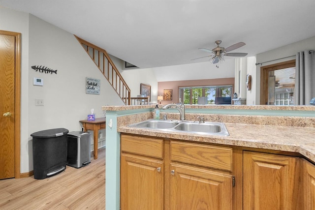 W5204 N Osprey Dr, New Lisbon, WI 53950 - kitchen featuring a sink, light wood-type flooring, light countertops, and a ceiling fan
