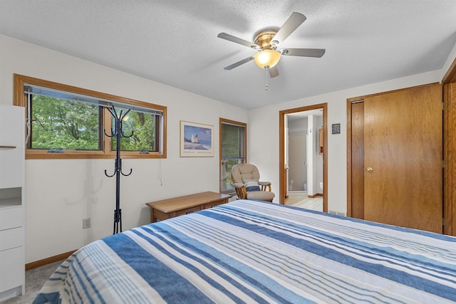 W5204 N Osprey Dr, New Lisbon, WI 53950 - bedroom with baseboards, a closet, light carpet, a ceiling fan, and a textured ceiling