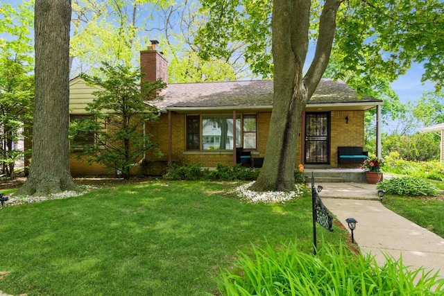 5638 N 35th St, Milwaukee, WI 53209 - view of front of house with a front yard, a chimney, and brick siding