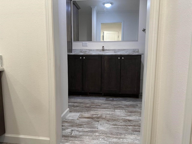 32793 Fulton St, Gotham, WI 53540 - bathroom featuring vanity, wood finished floors, baseboards, and a textured wall