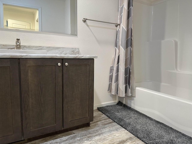 32793 Fulton St, Gotham, WI 53540 - full bath with wood finished floors, vanity, shower / bathtub combination, and baseboards