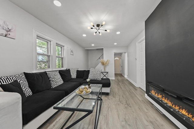 6028 N 38th St, Milwaukee, WI 53209 - living room with a chandelier, light wood-type flooring, recessed lighting, a glass covered fireplace, and baseboards