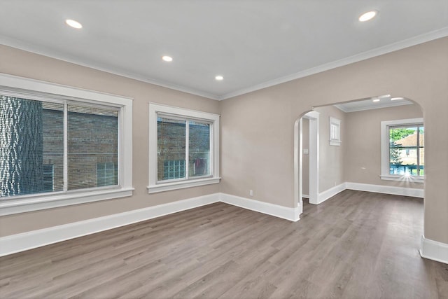 1632 S 77th St, West Allis, WI 53214 - empty room featuring arched walkways, ornamental molding, wood finished floors, baseboards, and recessed lighting