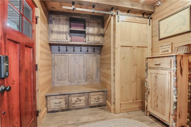 14856W Valhalla Dr, Hayward, WI 54843 - mudroom featuring wood walls, light wood finished floors, and a barn door