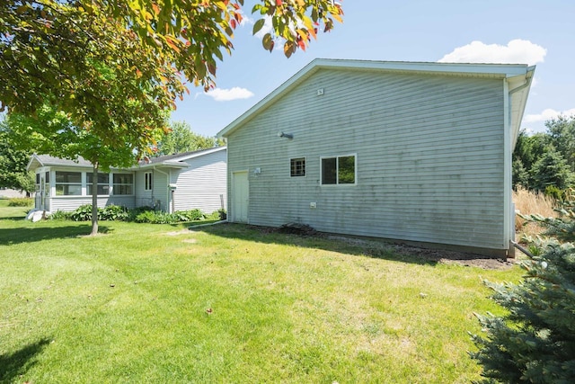 W5670 School Rd, Walworth, WI 53184 - view of property exterior with a yard and a sunroom