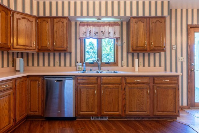 W5670 School Rd, Walworth, WI 53184 - kitchen featuring stainless steel dishwasher, wallpapered walls, a sink, brown cabinets, and light countertops