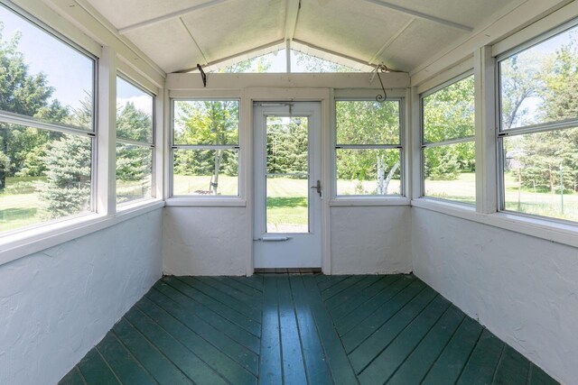 W5670 School Rd, Walworth, WI 53184 - unfurnished sunroom featuring lofted ceiling, a textured wall, and wood-type flooring