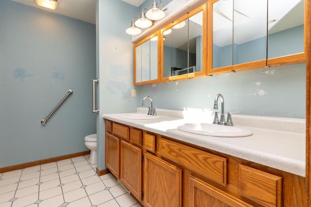 W5670 School Rd, Walworth, WI 53184 - full bathroom featuring toilet, double vanity, tile patterned floors, and baseboards