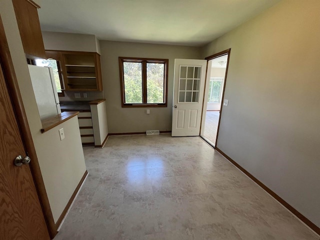 425 Mineau Pkwy, Madison, WI 53711 - kitchen featuring baseboards, brown cabinets, and dark countertops