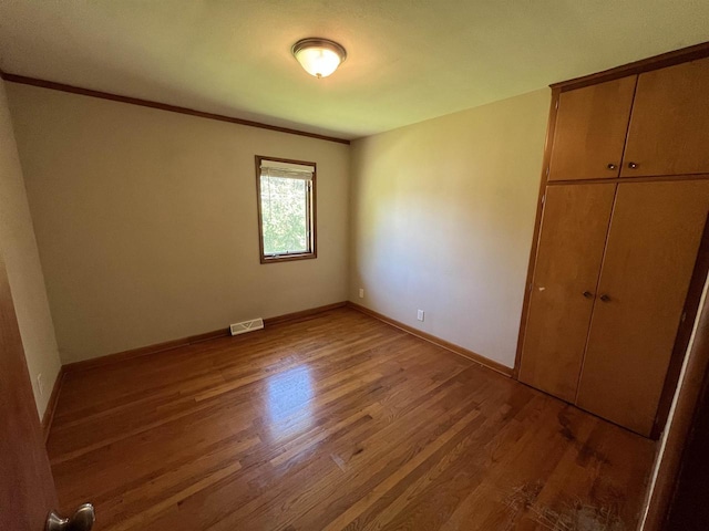 425 Mineau Pkwy, Madison, WI 53711 - unfurnished bedroom featuring light wood-type flooring, baseboards, a closet, and ornamental molding