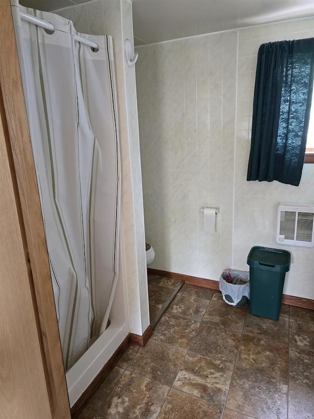 Pine Ln, Bloomington, WI 53804 - full bath featuring a stall shower, toilet, stone finish flooring, and baseboards