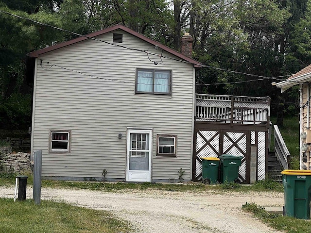 756 W Happy Hollow Rd, Janesville, WI 53546 - back of house with a chimney and a deck