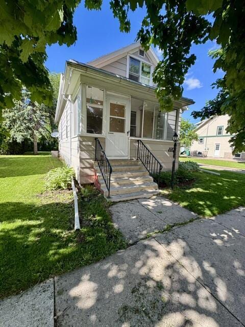 219 E 9th St, Fond Du Lac, WI 54935 - view of front of property with a front yard and entry steps