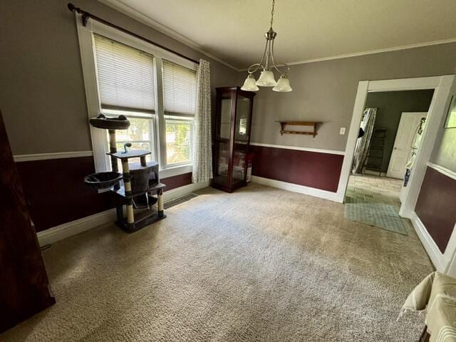 219 E 9th St, Fond Du Lac, WI 54935 - dining space featuring ornamental molding, baseboards, a chandelier, and carpet floors