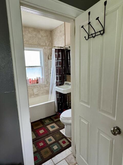 219 E 9th St, Fond Du Lac, WI 54935 - bathroom with toilet, shower / bath combo, and tile patterned floors