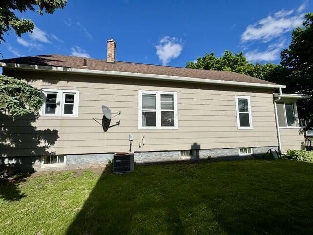219 E 9th St, Fond Du Lac, WI 54935 - back of house with a lawn and a chimney
