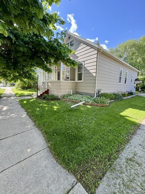 219 E 9th St, Fond Du Lac, WI 54935 - view of home's exterior featuring a lawn