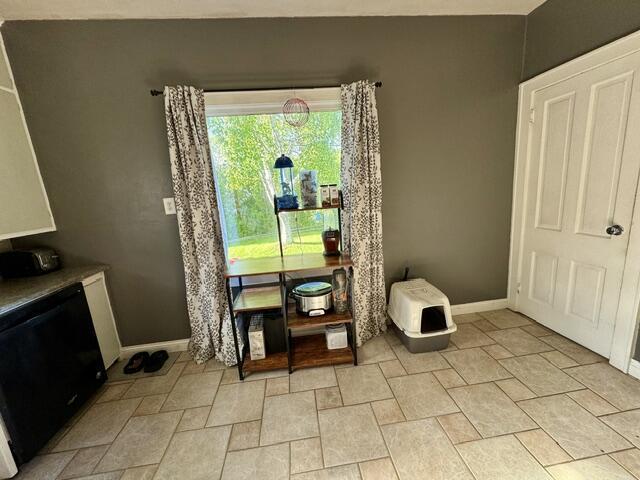 219 E 9th St, Fond Du Lac, WI 54935 - dining room featuring baseboards