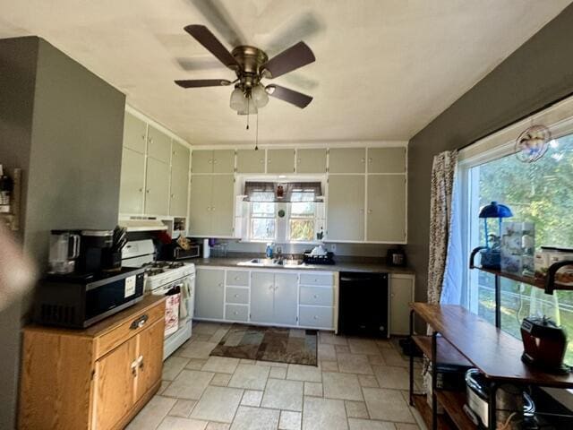 219 E 9th St, Fond Du Lac, WI 54935 - kitchen with white range with gas stovetop, black dishwasher, stone tile floors, under cabinet range hood, and ceiling fan
