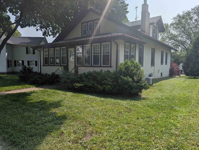 323 S Janesville St, Whitewater, WI 53190 - view of side of property featuring a chimney and a yard