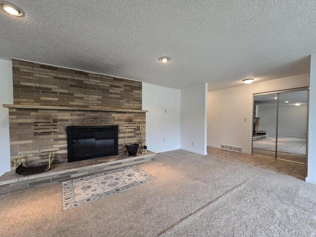 4211 State Highway 173, Nekoosa, WI 54457 - unfurnished living room featuring carpet floors, a brick fireplace, and a textured ceiling
