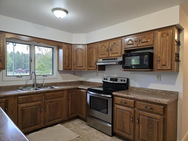 4211 State Highway 173, Nekoosa, WI 54457 - kitchen featuring electric range, black microwave, under cabinet range hood, a sink, and dark countertops