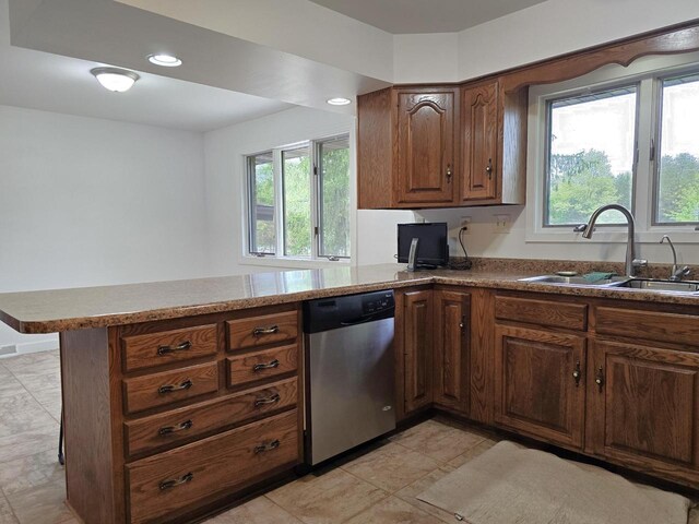 4211 State Highway 173, Nekoosa, WI 54457 - kitchen featuring stainless steel dishwasher, a sink, a peninsula, brown cabinets, and recessed lighting