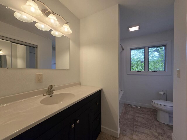 4211 State Highway 173, Nekoosa, WI 54457 - bathroom featuring vanity, toilet, shower / tub combination, and baseboards