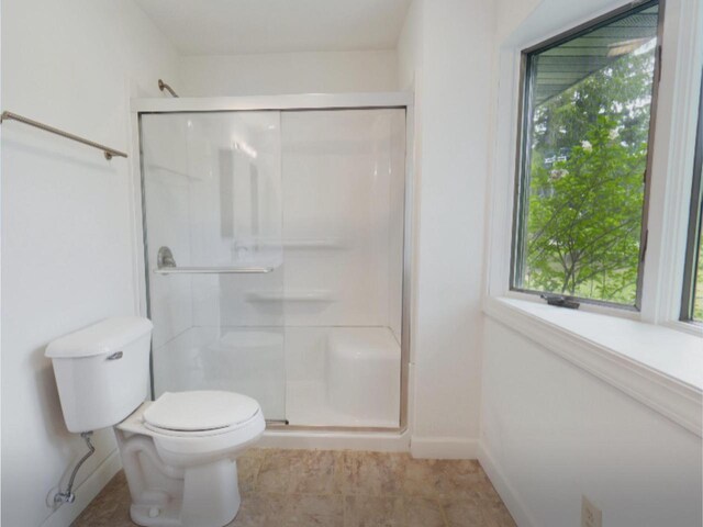 4211 State Highway 173, Nekoosa, WI 54457 - bathroom featuring a shower stall, plenty of natural light, and toilet