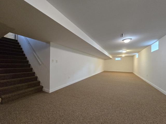 4211 State Highway 173, Nekoosa, WI 54457 - below grade area featuring stairway, baseboards, and carpet