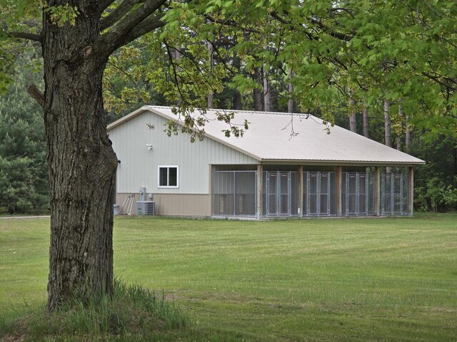 4211 State Highway 173, Nekoosa, WI 54457 - back of house with a lawn, central AC unit, and metal roof