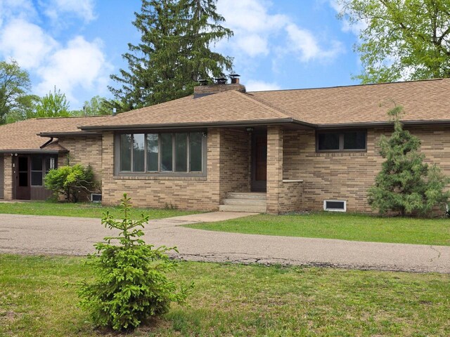 4211 State Highway 173, Nekoosa, WI 54457 - ranch-style home with brick siding, a front yard, and a shingled roof