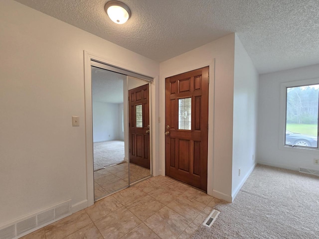 4211 State Highway 173, Nekoosa, WI 54457 - foyer entrance with light colored carpet, a textured ceiling, and baseboards