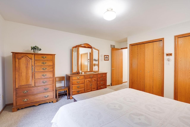 741 Kensington Sq, Stoughton, WI 53589 - bedroom featuring light colored carpet and two closets