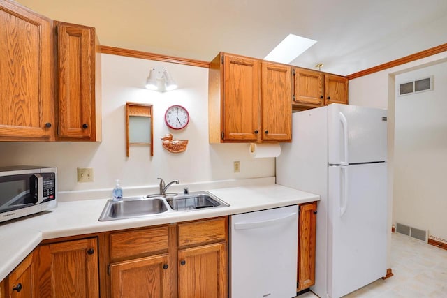 741 Kensington Sq, Stoughton, WI 53589 - kitchen with white appliances, a sink, light countertops, and brown cabinetry