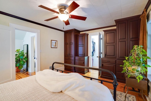 350 Washington St, Prairie Du Sac, WI 53578 - bedroom with wood finished floors, ornamental molding, a walk in closet, and ceiling fan