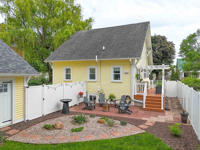 350 Washington St, Prairie Du Sac, WI 53578 - back of house with a wooden deck, a fenced backyard, a pergola, a gate, and roof with shingles