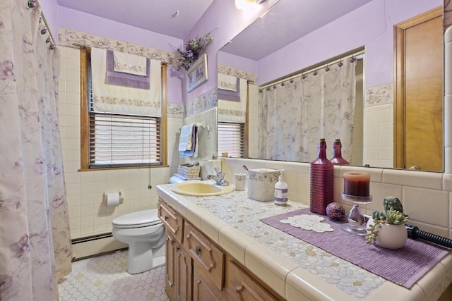 W156N8813 Pilgrim Rd, Menomonee Falls, WI 53051 - bathroom with a baseboard radiator, tile walls, vanity, toilet, and tile patterned flooring
