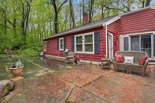 W156N8813 Pilgrim Rd, Menomonee Falls, WI 53051 - view of property exterior featuring a patio area, a chimney, and an outdoor hangout area